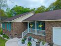 A close up aerial view of a charming brick home with inviting front porch at 2233 Glendale Dr, Charleston, SC 29414
