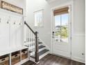 Bright foyer with coat rack, bench, and view of the neighborhood at 2632 Private Lefler Dr, Johns Island, SC 29455