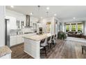 Open-concept kitchen with island, granite countertops, stainless steel appliances, and seating at 2632 Private Lefler Dr, Johns Island, SC 29455