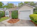 Exterior view showing attached garage and well-maintained landscaping around the perimeter of the home at 2777 Forest Dew Ct, Charleston, SC 29414