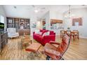 Spacious living room showcasing built-in shelving, vaulted ceiling, hardwood floor, and lots of natural light at 2777 Forest Dew Ct, Charleston, SC 29414