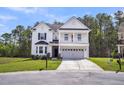 Charming two-story home with a second story balcony, attached garage, and well-manicured lawn at 280 Swamp Creek Ln, Moncks Corner, SC 29461