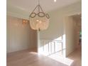 Spacious dining room featuring hardwood floors, a statement chandelier, and white wainscoting at 295 W Coleman Blvd, Mount Pleasant, SC 29464