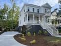 Charming two-story home with a large porch, landscaped front yard, and concrete driveway at 295 W Coleman Blvd, Mount Pleasant, SC 29464