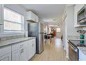Bright kitchen featuring stainless steel appliances, white cabinets, and granite countertops at 322 Lantana Dr, Charleston, SC 29407