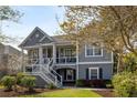 Charming two-story home featuring a covered front porch and a landscaped front yard at 3558 Stockton Dr, Mount Pleasant, SC 29466