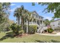 Beautiful two story traditional home with an elevated porch and tropical landscape features at 3734 St Ellens Dr, Mount Pleasant, SC 29466