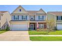 A well-manicured lawn complements this stylish two-story home with a two-car garage at 400 Dunlin Dr, Summerville, SC 29486