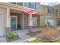 Inviting front porch featuring stone accents, an American flag, and decorative details at 400 Dunlin Dr, Summerville, SC 29486
