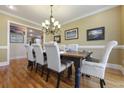 Dining room with hardwood floors, chandelier, and large table with seating for six at 4204 Magnolia Ct, North Charleston, SC 29420