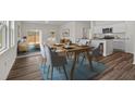 Inviting dining area showcasing an open-concept layout with modern decor, a dining table, and a view to the living room at 527 Pender Woods Dr, Summerville, SC 29486