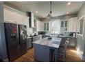 Modern kitchen with stainless steel appliances, island with seating, and stylish white and grey cabinetry at 527 W Butternut Rd, Summerville, SC 29483