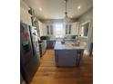 Bright kitchen with a large island, stainless steel appliances, and ample cabinet space at 527 W Butternut Rd, Summerville, SC 29483