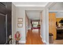 Inviting foyer with bamboo flooring, a view to the living room, and detailed trim work at 5276 7Th Green Dr, Hollywood, SC 29449