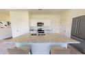 Elegant kitchen with large island, granite countertops, stainless steel appliances, and ample cabinet space at 531 Pender Woods Dr, Summerville, SC 29486