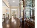 Elegant hallway with hardwood floors, a display cabinet, and views to the dining and kitchen areas at 547 Pontoon Rd, Huger, SC 29450