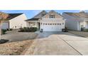 Charming single-Gathering home featuring a two-car garage, complimented with a well-manicured lawn, driveway, and sidewalk at 614 Beach Way, Summerville, SC 29486