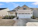 Charming home showcasing a well-manicured lawn and a spacious two-car garage beneath a complementary neutral color scheme at 614 Beach Way, Summerville, SC 29486