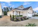 Beautiful home boasting manicured landscaping and a two-car garage, complemented by a well-maintained lawn at 614 Beach Way, Summerville, SC 29486