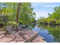 Waterfront backyard with chaise lounges on a private dock with scenic water views at 753 Lake Frances Dr, Charleston, SC 29412