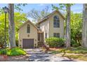 Charming two-story home with a well-manicured lawn and a driveway leading to an attached garage at 753 Lake Frances Dr, Charleston, SC 29412
