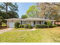 Traditional home showcasing a well-maintained lawn and established landscaping adding to its charm at 783 Dills Bluff Rd, Charleston, SC 29412