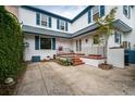 A charming white house exterior is shown with red brick steps leading to the front door at 8 Poulnot Ln, Charleston, SC 29401