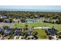 Stunning aerial view of a neighborhood with a golf course, a pond, and picturesque homes at 9 Intracoastal Ct, Isle of Palms, SC 29451