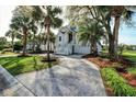 Elegant home showcasing a circular driveway, lush landscaping, and classic architectural details at 9 Intracoastal Ct, Isle of Palms, SC 29451