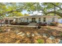Inviting home with a charming facade, showcasing mature trees and green lawn at 935 Lansing Dr, Mount Pleasant, SC 29464