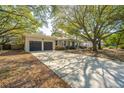 Beautiful ranch-style home with well-maintained lawn, mature trees, and a two car garage at 935 Lansing Dr, Mount Pleasant, SC 29464
