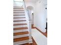 Bright staircase with hardwood stairs and white risers, leading to the upper level of the home at 10 Killians St, Charleston, SC 29403