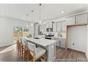 Modern kitchen featuring gray cabinets, quartz countertops, an island with seating, and stainless steel appliances at 1005 Toland Dr # 44P, Saint George, SC 29477