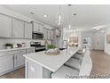 Modern kitchen with gray cabinets, an island with seating, stainless steel appliances, and pendant lighting at 1005 Toland Dr # 44P, Saint George, SC 29477