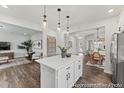 Open kitchen with kitchen island, pendant lights, and stainless steel refrigerator at 1007 Toland Dr # 45P, Saint George, SC 29477