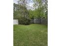 Backyard with a combination of wooden and white fences surrounded by mature trees and greenery at 108 Sandlewood Dr, Summerville, SC 29483