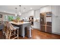 A modern kitchen boasts stainless steel appliances, white cabinets, and a gray island at 1111 Kilarney Rd, Mount Pleasant, SC 29464