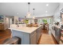 An island kitchen has pendant lighting, quartz countertops, and stainless appliances at 1111 Kilarney Rd, Mount Pleasant, SC 29464