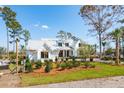 White home with metal roof, windows, and professionally landscaped yard at 116 Peninsula Dr, Ravenel, SC 29470