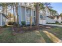 Charming two-story home with light-blue painted wood surrounded by trees at 117 Lewisfield Dr, North Charleston, SC 29418