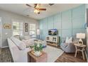 Cozy living room with stylish decor, comfortable seating, and a modern accent wall with natural light at 123 Hyacinth St, Summerville, SC 29483