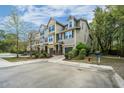 Charming multi-Gathering exterior showcasing manicured lawn, individual garages, and neatly paved driveways in serene area at 1271 Dingle Rd, Mount Pleasant, SC 29466