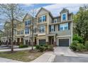 Inviting townhomes featuring individual garages, manicured greenery, and cozy front entrances add community charm at 1271 Dingle Rd, Mount Pleasant, SC 29466