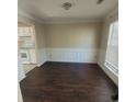 Well-lit dining room with hardwood floors, decorative chair rail, and view into the kitchen space at 1391 Center Lake Dr, Mount Pleasant, SC 29464