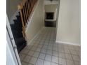 Inviting entryway featuring a staircase, tiled floors, and a view of the fireplace in the living area at 1391 Center Lake Dr, Mount Pleasant, SC 29464