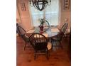 Dining room features hardwood floors, large window, and wooden table with seating for four at 1414 N Sherwood Dr, Charleston, SC 29407