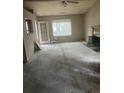 Spacious living room area featuring a ceiling fan, fireplace, exterior door, and natural light at 143 Mickler Dr, Ladson, SC 29456