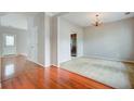 Bright living room featuring hardwood and carpet floors with modern chandelier at 2019 Azalee Ln, Summerville, SC 29483
