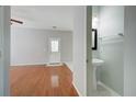 Open living space with tile and wood floors featuring a bathroom and entry door at 2019 Azalee Ln, Summerville, SC 29483
