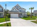 Beautiful two-story home with a well-maintained lawn, attached garage, and traditional design at 215 Center Hill Ct, Summerville, SC 29485